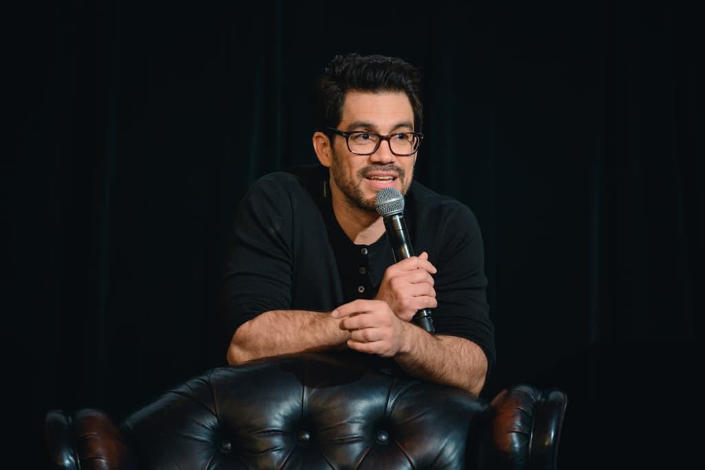 Tai Lopez is Holding a Microphone and Speaking on a Show