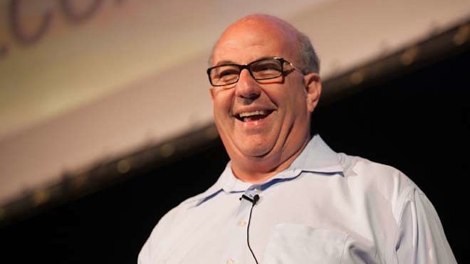 Jeff Hoffman stands on stage and smiles